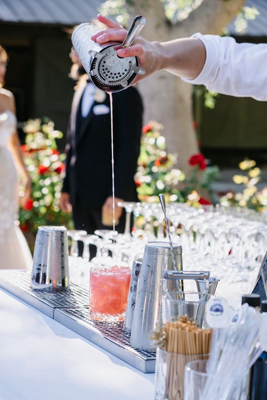 Bartender shaking and pouring a cocktail