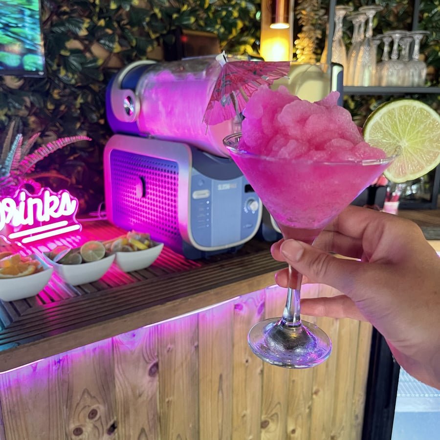 Frozen pink cocktail served in a martini glass